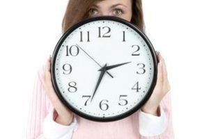 Young woman holding white whatch