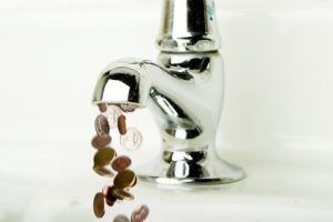 Money flowing out of a retro bathroom tap.