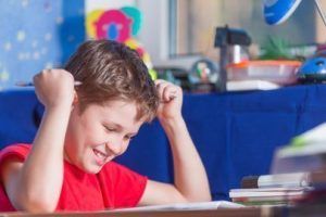 Teenage boy sitting and preparing his homework
